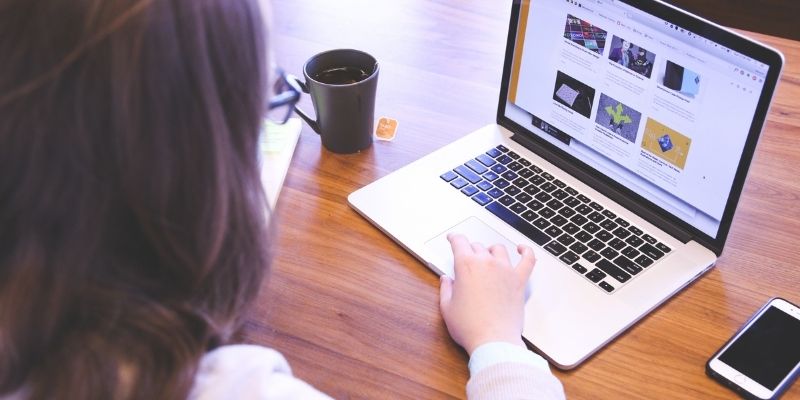 hands typing on laptop to promote a business